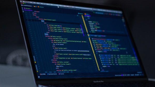 Code editor on a laptop screen showing website development